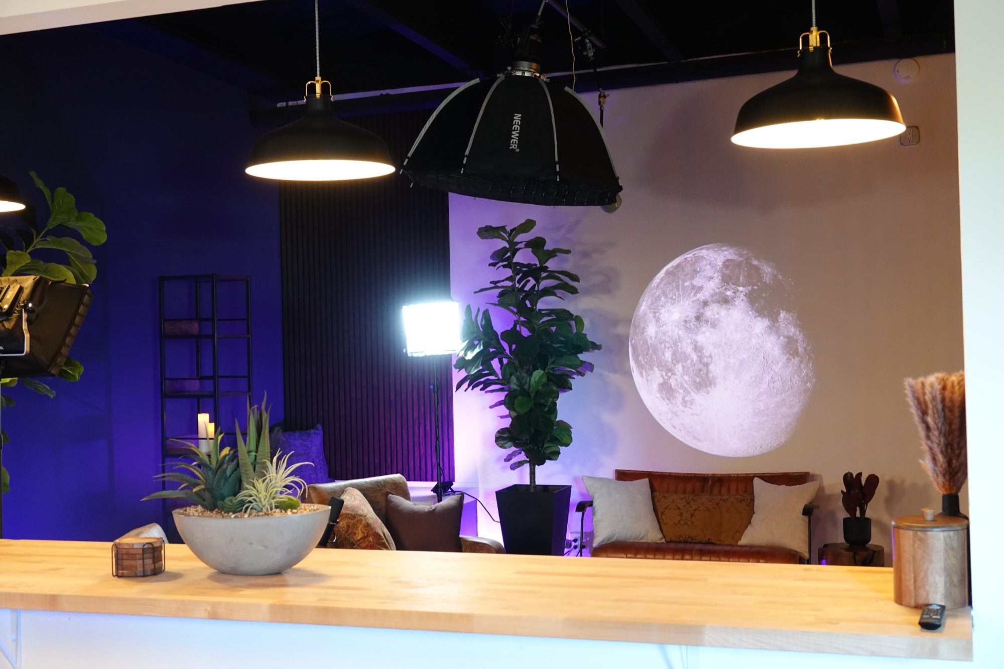 The set with overhead pendant lamps, a softbox and the lit backdrop in place